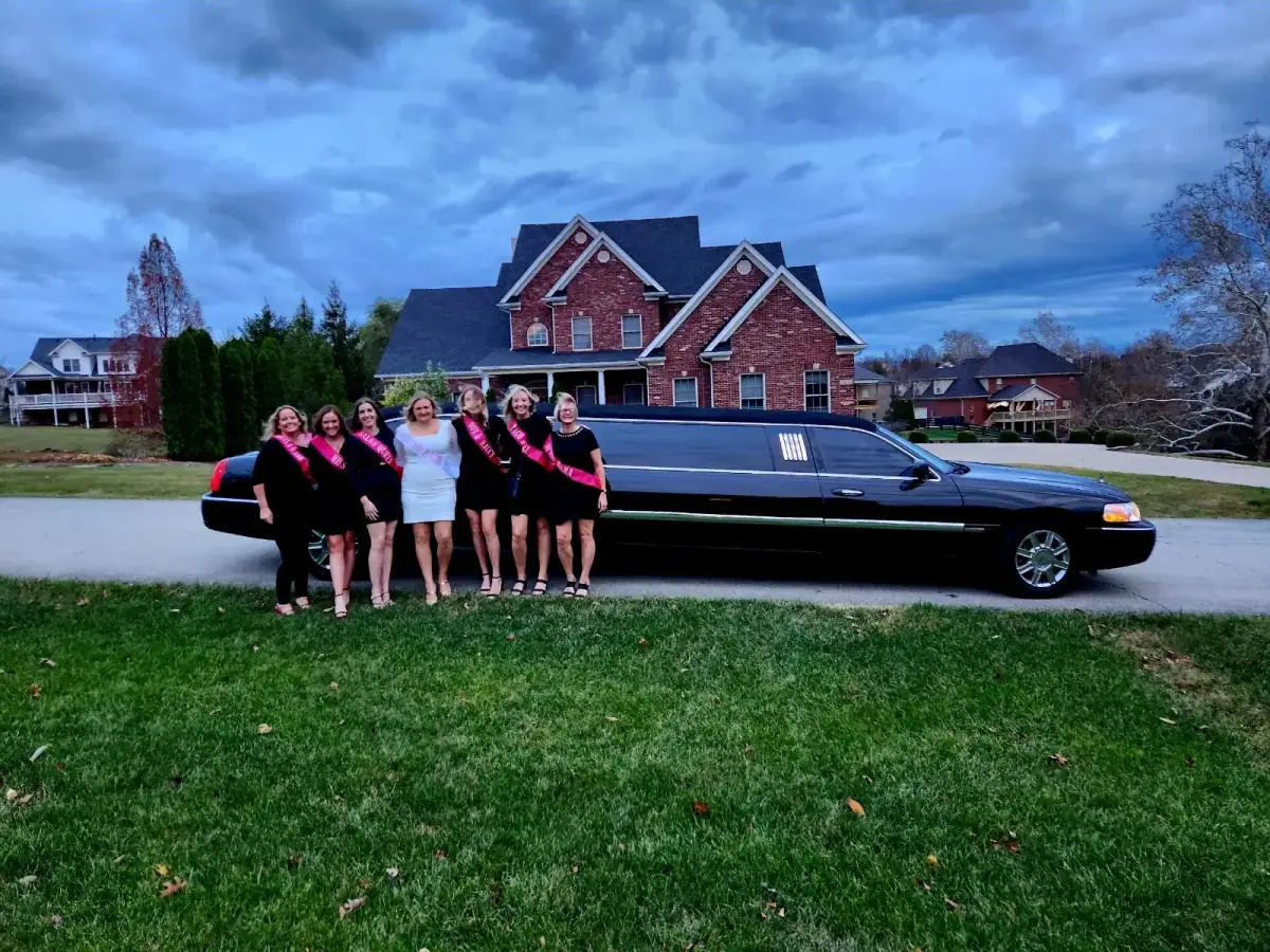 Bachelorette group beside a black stretch limousine