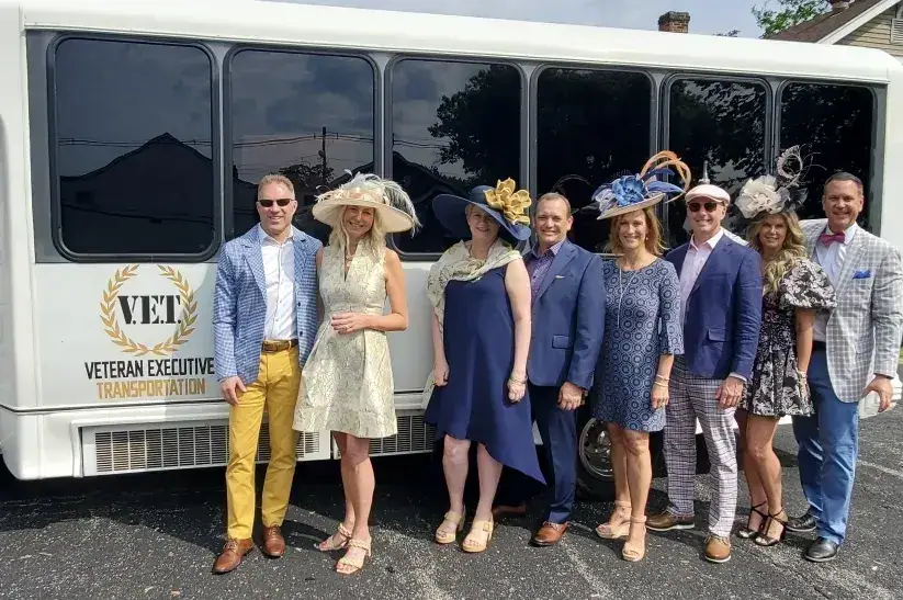 Derby guests in front of the white VET party bus