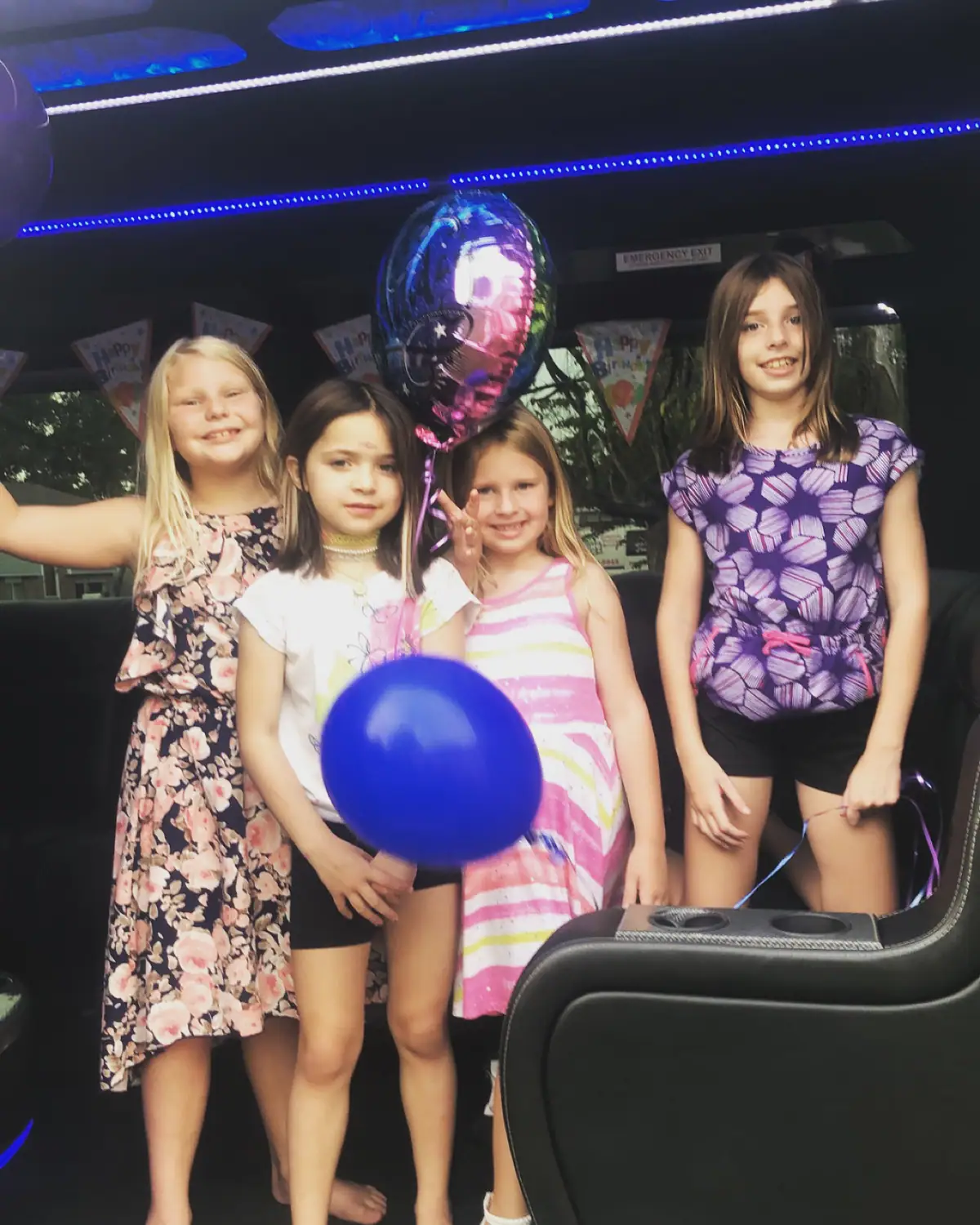 Children celebrating a birthday inside a party bus