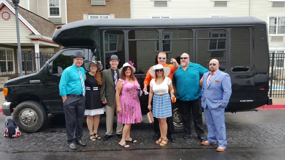 Derby guests in front of a black party bus