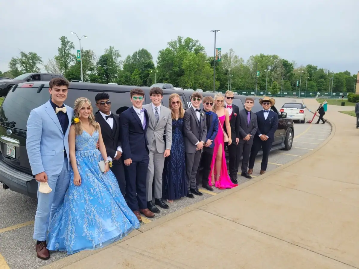 Prom group in formal wear beside a black stretch SUV limousine in Floyds Knobs, IN