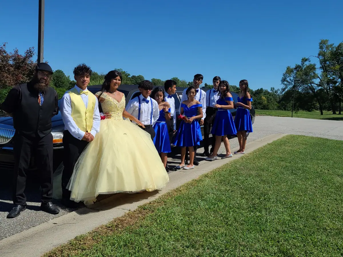 Quinceanera court beside a black stretch SUV limousine