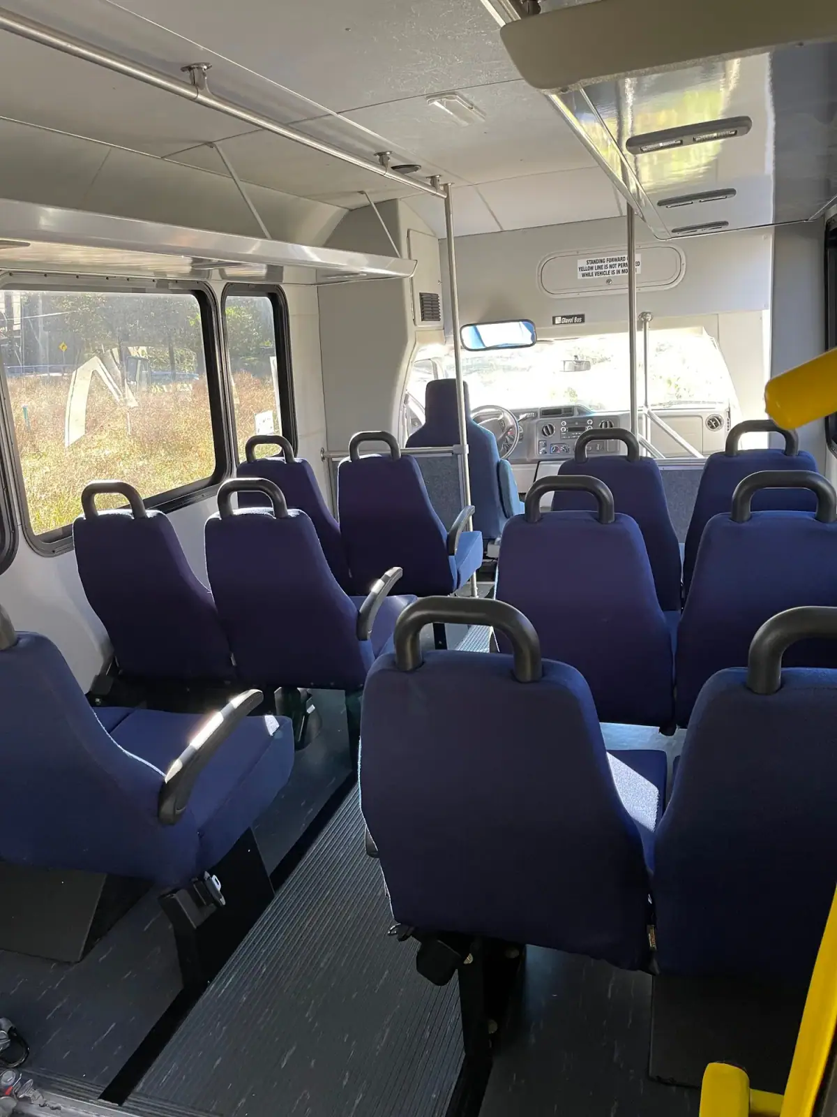 Captain chairs and blue lighting inside a shuttle bus