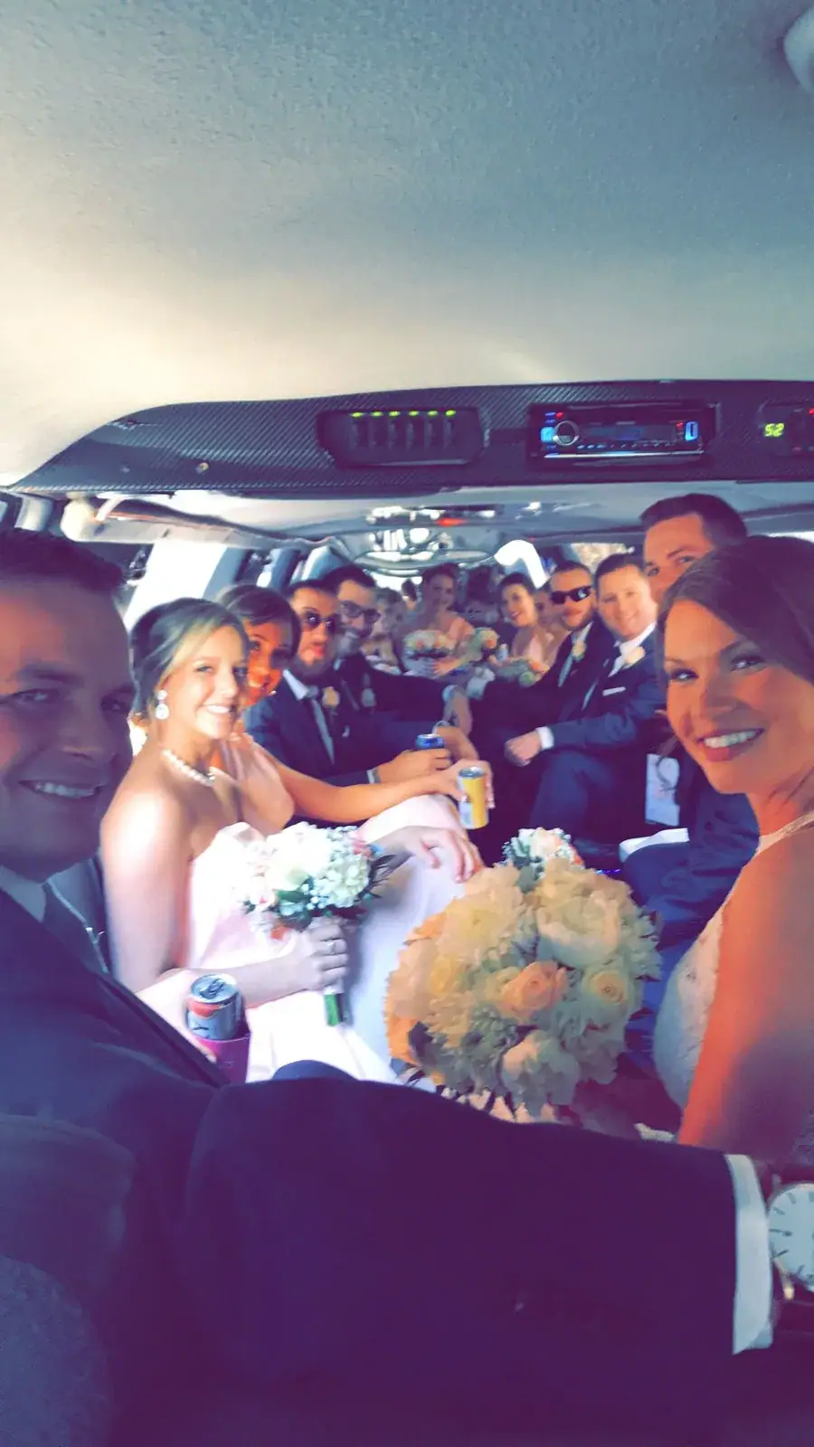 Wedding party seated inside a stretch limousine